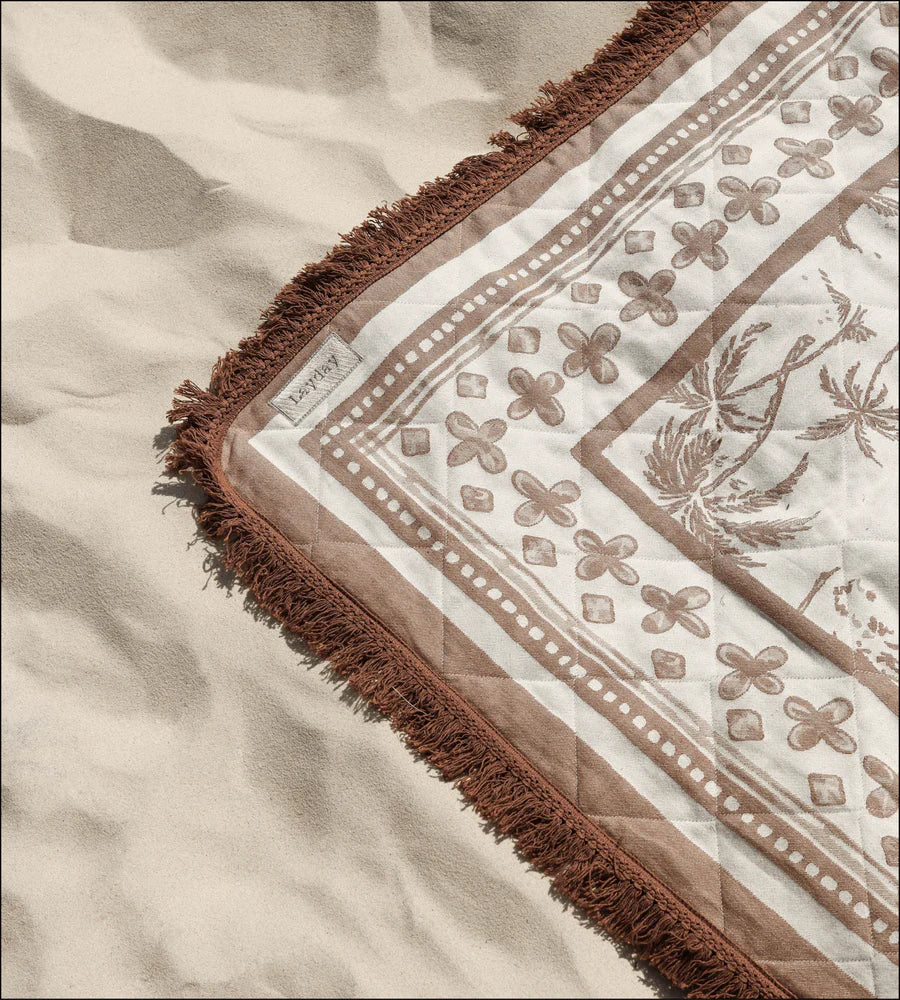 Textile with intricate patterns on a Layday blanket and frayed edges